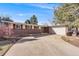 Charming single-story home with a brick facade, attached garage, and spacious driveway on a sunny day at 6261 S Adams Dr, Centennial, CO 80121