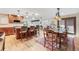 Open-concept kitchen and dining area with hardwood floors and natural light at 6261 S Adams Dr, Centennial, CO 80121