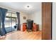 Well-lit office space with hardwood floors and sliding door to back patio at 6261 S Adams Dr, Centennial, CO 80121