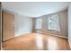 Bedroom featuring hardwood floors, a closet, and two large windows for natural light at 9651 W Cornell Pl, Lakewood, CO 80227