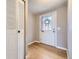 Welcoming entryway features hardwood floors, a coat closet, and a windowed front door providing natural light at 9651 W Cornell Pl, Lakewood, CO 80227