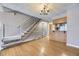 Open concept living area with wood flooring, a staircase, and a kitchen bar area at 9651 W Cornell Pl, Lakewood, CO 80227