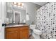 Bathroom featuring wood vanity, shower with curtain, and modern toilet at 3780 S Quemoy Way, Aurora, CO 80018
