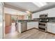 Bright kitchen featuring stainless steel appliances and an open view to dining room at 3780 S Quemoy Way, Aurora, CO 80018