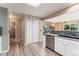 Bright kitchen featuring stainless steel appliances, hardwood floors, and modern countertops at 3780 S Quemoy Way, Aurora, CO 80018