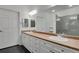 Bright bathroom featuring double sinks, a large mirror, modern lighting and a glass door walk-in shower at 2210 S Vaughn Way # 103, Aurora, CO 80014
