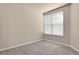 Bright bedroom featuring carpet, a large window offering natural light and neutral-toned walls at 2210 S Vaughn Way # 103, Aurora, CO 80014