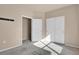 Bedroom featuring carpet, an open doorway, and double closets with white doors at 2210 S Vaughn Way # 103, Aurora, CO 80014