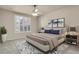 Comfortable bedroom with ceiling fan, large window and neutral color palette at 2210 S Vaughn Way # 103, Aurora, CO 80014