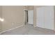 Bedroom featuring neutral colors, carpet, a double door closet, and an open doorway at 2210 S Vaughn Way # 103, Aurora, CO 80014