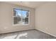 Cozy bedroom with plush carpet, a large window offering natural light and neutral-toned walls at 2210 S Vaughn Way # 103, Aurora, CO 80014