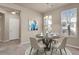 Cozy dining area with modern chandelier, four chairs and a round table at 2210 S Vaughn Way # 103, Aurora, CO 80014
