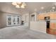 Spacious living room with fireplace, kitchen access and bright light from large glass doors at 2210 S Vaughn Way # 103, Aurora, CO 80014