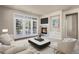 Bright living room features a fireplace, balcony access and modern neutral finishes at 2210 S Vaughn Way # 103, Aurora, CO 80014