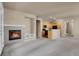 Bright and open living area featuring a fireplace and access to the kitchen at 2210 S Vaughn Way # 103, Aurora, CO 80014