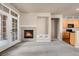 Cozy living room with fireplace and natural light from glass patio doors, kitchen access at 2210 S Vaughn Way # 103, Aurora, CO 80014