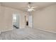 Spacious bedroom with a ceiling fan, neutral paint, and access to an en-suite bathroom at 2210 S Vaughn Way # 103, Aurora, CO 80014