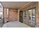 A covered brick patio with a security door and sliding glass doors at 2210 S Vaughn Way # 103, Aurora, CO 80014