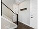 Hallway featuring sleek design elements, like a dark wood coat rack and modern hardware at 11350 W Grand Ave, Littleton, CO 80127