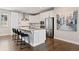 Modern kitchen with white cabinets, stainless steel appliances, and a center island with bar seating at 11350 W Grand Ave, Littleton, CO 80127