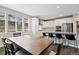 Open concept kitchen and dining area with modern white cabinets and stainless steel appliances at 11350 W Grand Ave, Littleton, CO 80127