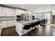 A modern kitchen with an island, stainless appliances, and open floor plan at 11350 W Grand Ave, Littleton, CO 80127