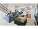 Stylish living room with sofa, kitchen view, and staircase at 11350 W Grand Ave, Littleton, CO 80127
