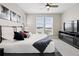 Comfortable main bedroom featuring a ceiling fan, television, and natural light from two large windows at 11350 W Grand Ave, Littleton, CO 80127