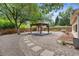Beautiful backyard featuring a gazebo, rock landscaping, and stepping stone path at 3064 S Grape Way, Denver, CO 80222