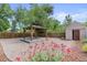 Charming backyard featuring a gazebo, shed, and landscaped flower garden at 3064 S Grape Way, Denver, CO 80222