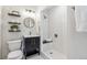 Modern bathroom featuring a sleek black vanity, stylish mirror, and tiled walk-in shower at 3064 S Grape Way, Denver, CO 80222