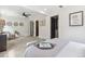 Spacious bedroom with a ceiling fan, open doorways, and modern decor at 3064 S Grape Way, Denver, CO 80222