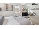Open bedroom with neutral decor, comfortable seating area, and plenty of natural light at 3064 S Grape Way, Denver, CO 80222