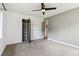 Spacious bedroom featuring a ceiling fan, closet, and a neutral color palette at 3064 S Grape Way, Denver, CO 80222