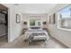 Bright bedroom featuring neutral decor, large window, and cozy bed with a throw blanket at 3064 S Grape Way, Denver, CO 80222