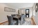 This dining room features a modern rug, large windows, and a black door at 3064 S Grape Way, Denver, CO 80222