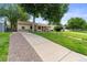 Single-story home with a well-manicured lawn and a long driveway at 3064 S Grape Way, Denver, CO 80222
