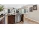 The open kitchen boasts granite countertops, stainless steel appliances, and an eat in counter at 3064 S Grape Way, Denver, CO 80222