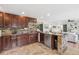 This beautiful kitchen features granite countertops, an eat in counter, and stone accents at 3064 S Grape Way, Denver, CO 80222