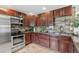 This kitchen features granite countertops, stainless steel appliances, and warm wood cabinets at 3064 S Grape Way, Denver, CO 80222