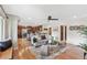 Open-concept living room and kitchen with hardwood floors and modern decor at 3064 S Grape Way, Denver, CO 80222