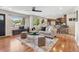 Spacious living room with hardwood flooring that flows into the kitchen at 3064 S Grape Way, Denver, CO 80222