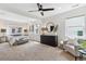 This main bedroom features plush carpet, neutral walls, and a ceiling fan at 3064 S Grape Way, Denver, CO 80222