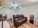 Finished basement bedroom with leather couch and wood-look floors at 268 Belford Dr, Northglenn, CO 80260