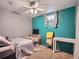 Basement bedroom with teal feature wall and a double bed at 268 Belford Dr, Northglenn, CO 80260