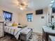 Main bedroom with striped bedding, ceiling fan, and plenty of closet space at 268 Belford Dr, Northglenn, CO 80260