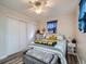 Bedroom with double closet, ceiling fan, and sunflower bedding at 268 Belford Dr, Northglenn, CO 80260