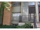 Cozy condo entrance with brick accents, iron railing and secure front door at 3548 S Hillcrest Dr # 2, Denver, CO 80237