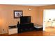 Living room with hardwood floors, a large TV and a wall mounted clock at 3548 S Hillcrest Dr # 2, Denver, CO 80237