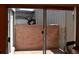 Private patio area outside sliding door, enclosed by brick walls at 3548 S Hillcrest Dr # 2, Denver, CO 80237